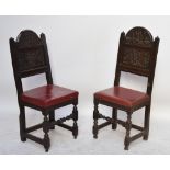 A pair of 17th century oak back stools, each with carved arched panelled back,