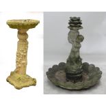 A composite stone bird bath in the form of a pillar with mice running up and ivy,