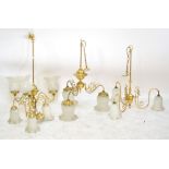 A brass three branch ceiling light with white opaque shades, height 70cm,