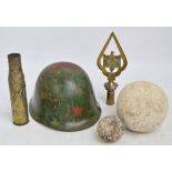 A 3" diameter cannonball, a 6" diameter stone cannonball, a "Trench Art" vase, a helmet,