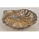 An Edward VII hallmarked silver scallop shaped dish with pierced and embossed decoration,