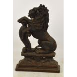 A cast iron doorstop modelled as a seated lion on pedestal base, height 38cm.