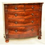 A large Victorian mahogany bowfront chest of two short and three long drawers with carved capitols