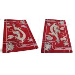 A pair of Chinese rugs depicting a dragon amongst clouds within ornamental and floral border,