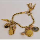 A 19th century yellow gold rope twist link charm bracelet suspending eight various charms including