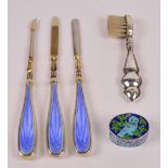 A George V hallmarked silver and blue guilloche enamel decorated three piece manicure set,