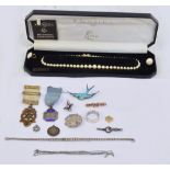 A small quantity of costume jewellery including a 9ct rose gold bar brooch in the form of a bow,