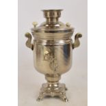 An electrical metal samovar with lid, twin handles, tap raised on shaped square support,