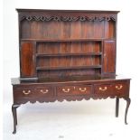 An early 19th century oak and mahogany crossbanded dresser,