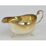 An Elizabeth II hallmarked silver sauce boat with rope twist rim and leaf capped loop handle,