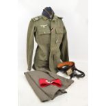 A WWII German GD (Gross Deutschland) felt uniform jacket with a badge and ribbons,