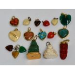 A group of pendants including a carved Chinese yellow metal mounted seated figure,
