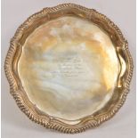 A William IV hallmarked silver salver of shaped circular form, bearing inscribed "Presented to R.C.