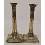 A pair of George V hallmarked silver candlesticks modelled as Corinthian columns,