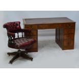 A walnut pedestal desk with leather top with crossbanded edge with three frieze drawers and two