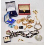 A quantity of costume jewellery including a 9ct yellow gold floral set dress ring, various brooches,