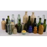 A quantity of late 19th century/early 20th century glass and stoneware bottle relating to