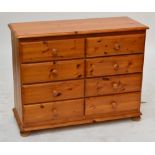 A pine chest of drawers with two formations of four drawers above turned bun feet, 107 x 43cm,