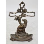 A Victorian cast iron stick stand modelled as a seated dog beneath tangled branches acting as two