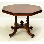 A late Victorian burr walnut and ebony inlaid octagonal centre table raised on four fluted and