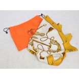 HERMES; a silk head scarf in "Les Cles" pattern (The Keys) with burnt yellow border, 89 x 89cm,