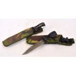 Two similar frog bayonets complete in camouflage canvas outer sleeves.