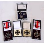 Four German WWII period Iron Crosses (two with ribbons) and a similar WWI example (5).