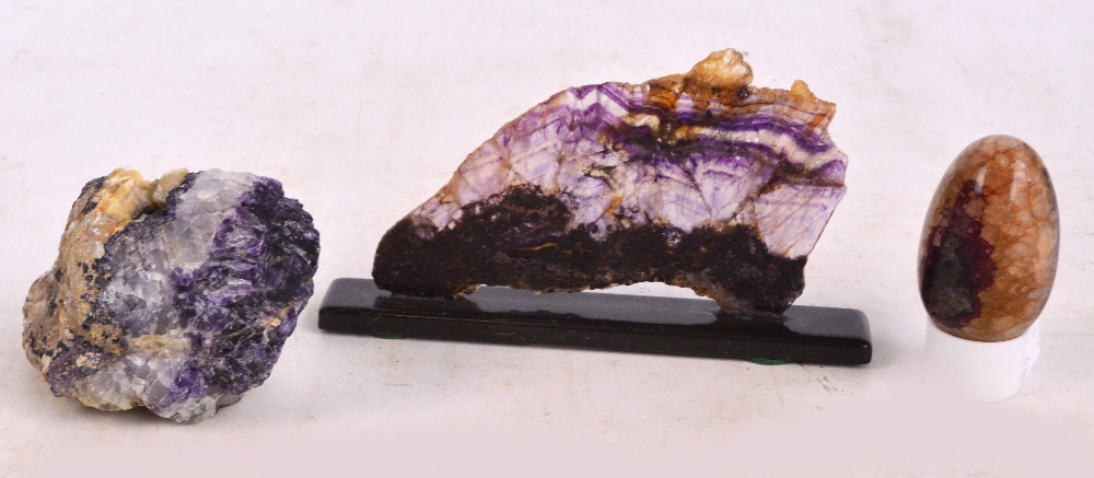 A polished Blue John egg and two Blue John samples, the largest being a sliced section,