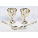 A pair of George VI hallmarked silver egg cups of plain form,