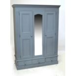 A French grey painted wardrobe with central mirrored section flanked by single doors,