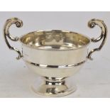 A George V hallmarked silver circular trophy bowl with scroll twin handles,