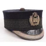 A Cater & Co of London peaked cap with stitched cloth wire work emblem inscribed "Gibraltar".