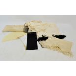 A group of five beige scarves, mainly with tassels,