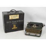 A vintage cased military issue portable typewriter, the case inscribed "119055 Major S.R. Brewer R.