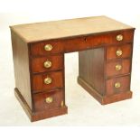 An early 19th century mahogany kneehole desk,