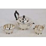 An Elizabeth II hallmarked silver three piece tea set of plain circular form with ribbed rim,