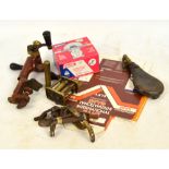 A collection of shooting related items including a combination rollover tool, a leather shot flask,