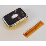 A cased George V hallmarked silver mounted and tortoiseshell baby brush of rounded rectangular form,