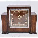 A 1940s walnut mantel clock, the square dial set with Arabic numerals, length 29.5cm.