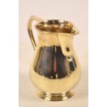 An Elizabeth II hallmarked silver jug of baluster with sparrow beak and loop handle,