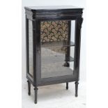 A French ebonised display cabinet with hinged glazed door enclosing two shelves, glass sides,