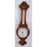 A 1920s carved oak banjo aneroid barometer/thermometer by Griffith Owen and Son, height 85cm.