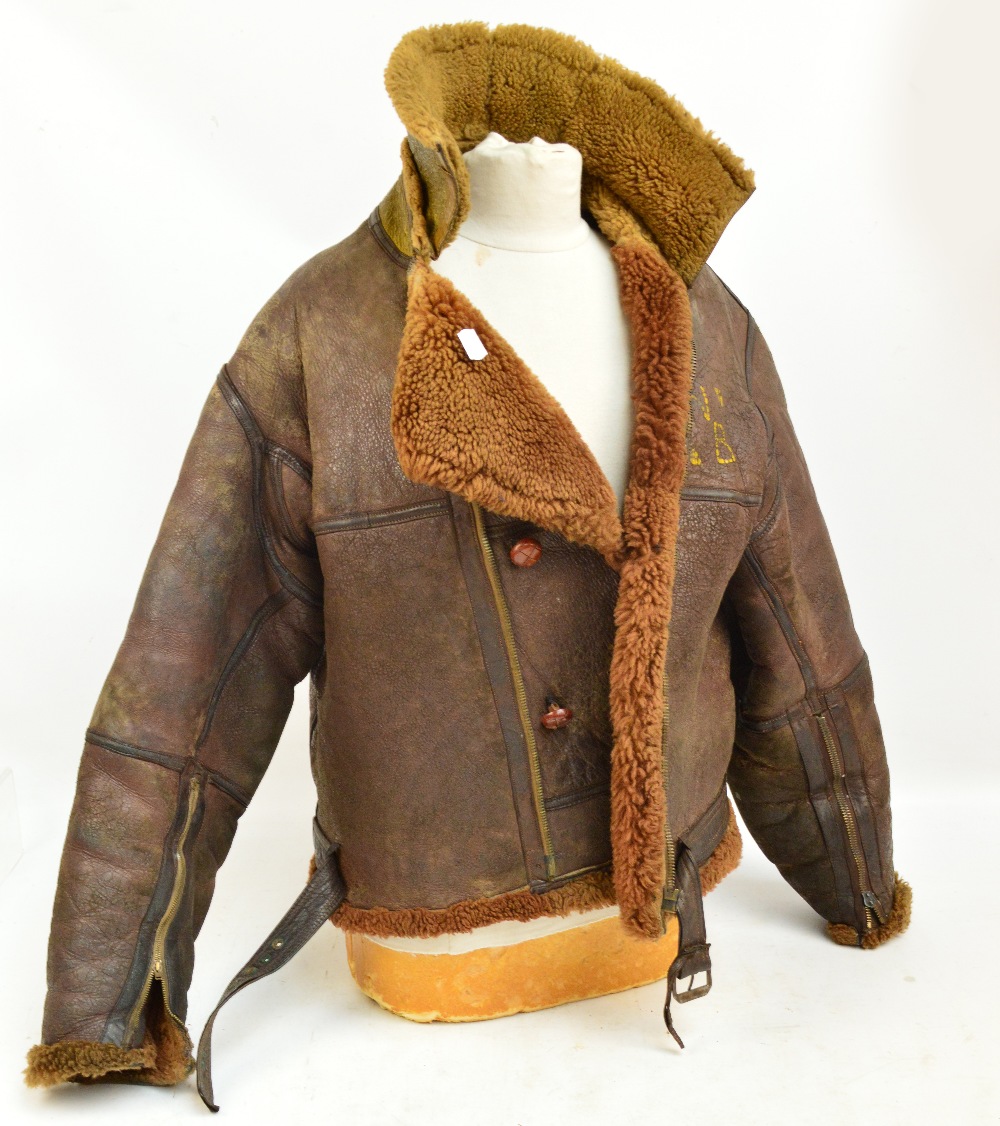 A WWII leather flying jacket, formerly the property of a Naval Air Gunner.