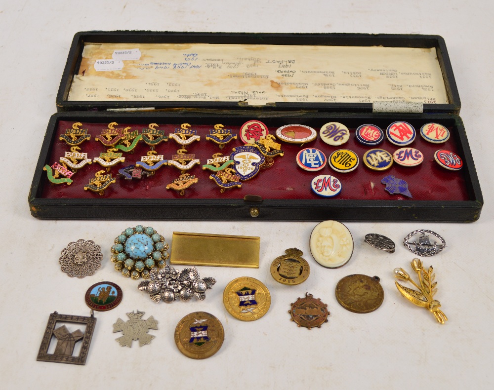 A collection of yellow metal and enamel decorated British Medical Association badges and a group of