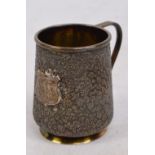 A late 19th century Russian silver shot measure of tapering form with floral textured ground and