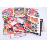 A quantity of Manchester United football programmes.