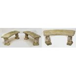 A set of three composite stone garden benches, each with two supports in the shape of squirrels,
