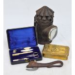 A WWI Queen Mary Christmas tin, a manicure set, a can opener in the form of a bull,