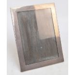 A large George V hallmarked silver mounted photograph frame of plain rectangular form,