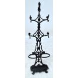 A cast iron hall stand with foliate knotted open decoration above two section umbrella stand and